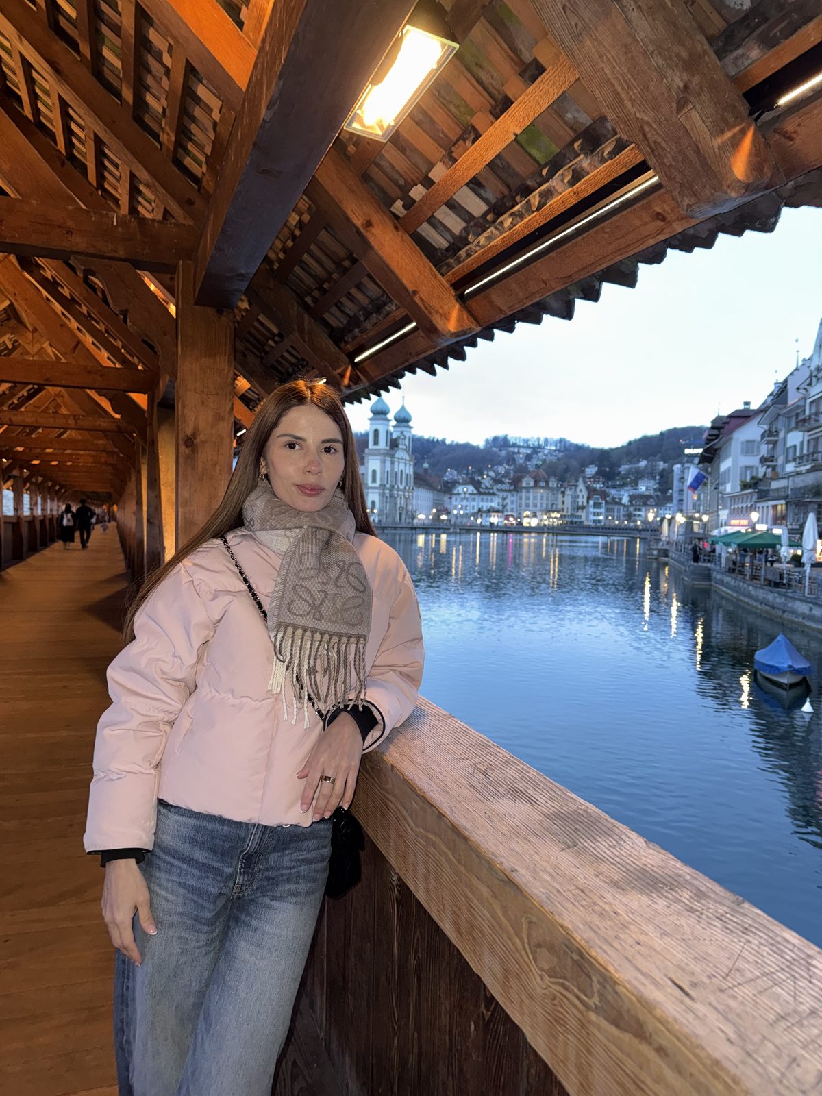 Isabella on a covered wooden bridge by a lake